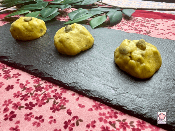 Laddus lined up on a rectangular slate plate