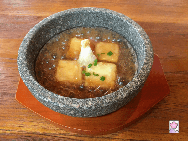 Agedashi Tofu is served in a thick sauce and topped with grated daikon radish