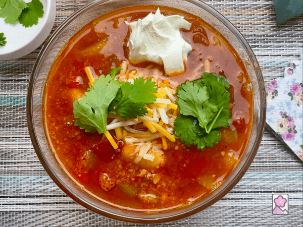 Ham and White Bean Chili topped with cheese, cilantro and sour cream